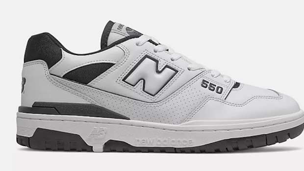 Side view of white and black New Balance shoe.
